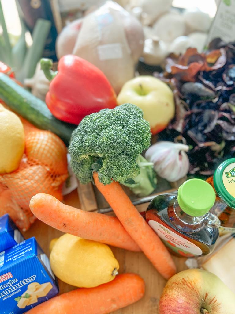 A variety of fresh produce and groceries arrayed on a table. 