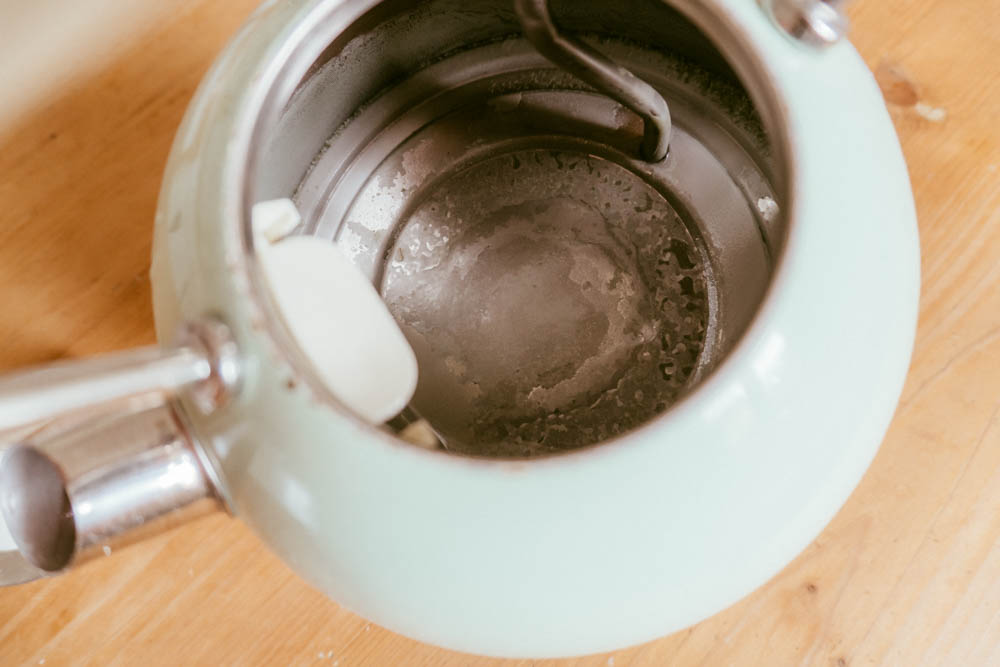 An open kettle sitting on a kitchen table