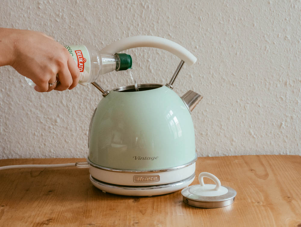 vinegar being pored into a kettle