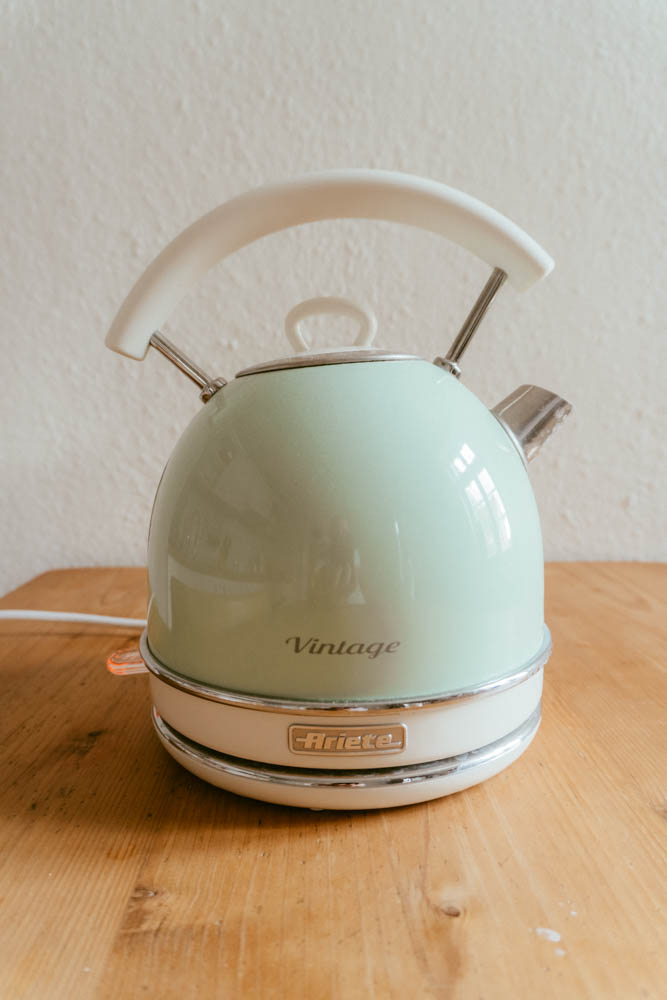 a kettle boiling on a kitchen table